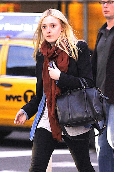 dakota fanning seen with her louis vuitton suitcase outside the