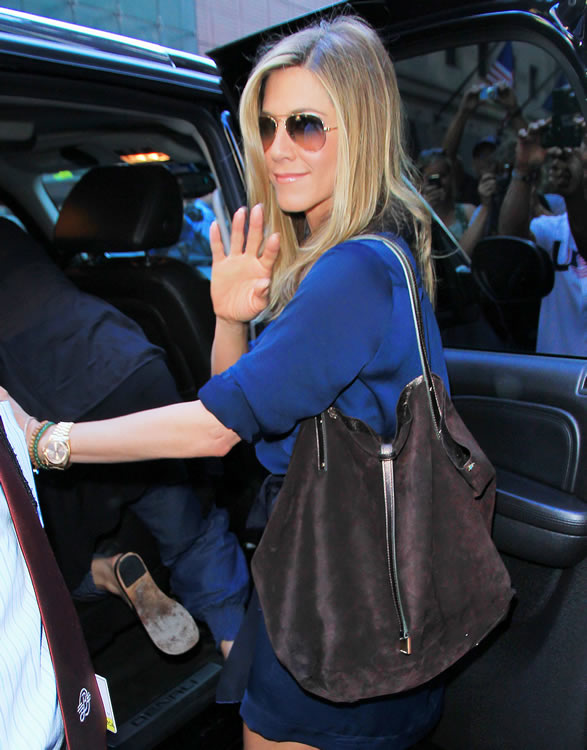 Jennifer Aniston in pink top, blue leggings and brown bucket bag in LA on  July 26 ~ I want her style - What celebrities wore and where to buy it.  Celebrity Style