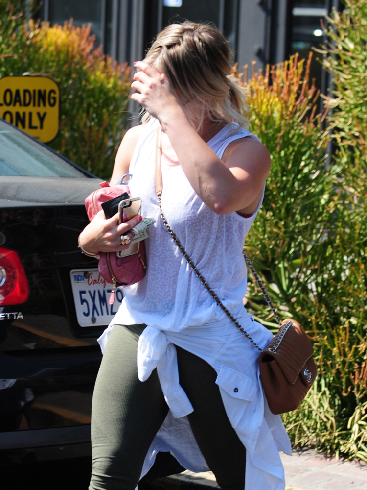 Hilary Duff totes giant Chanel bag while Luca snuggles security